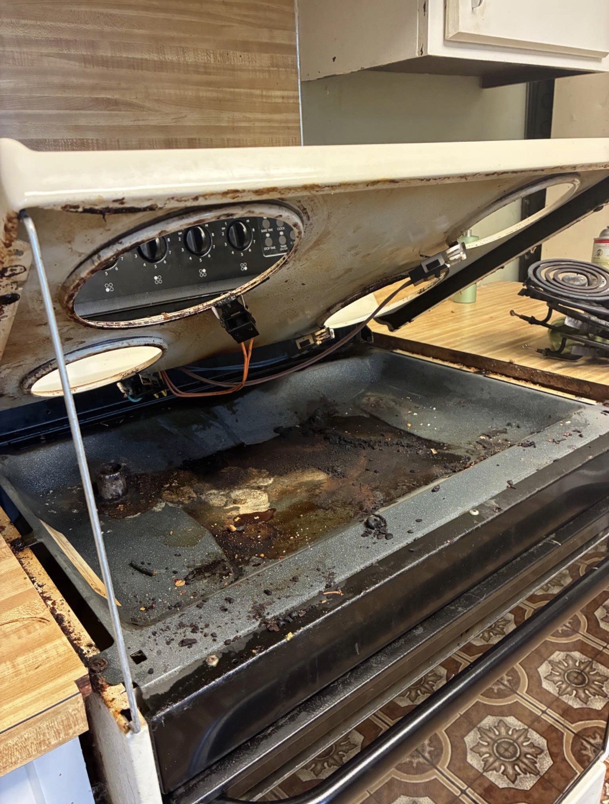 Beneath the cooktop before cleaning